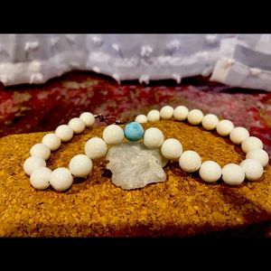 White bubblegum coral necklace with a Larimar offset.